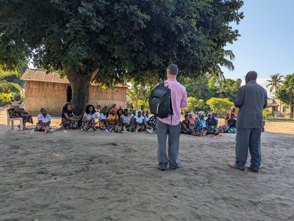 Research team members interact with former students and community members in Gaza province, Mozambique.